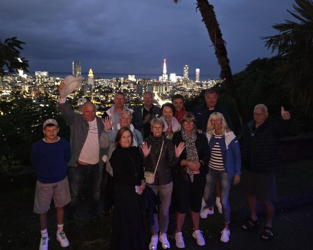 A group of guests at a viewpoint above Batumi in the evening