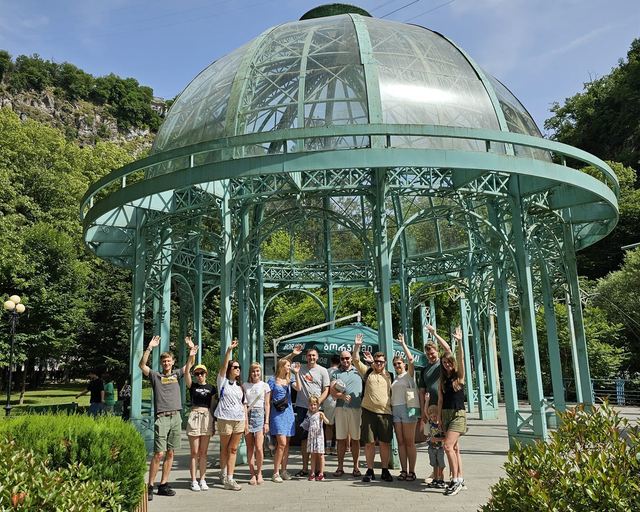 A group of guests by the glass pavilion of the Borjomi spring