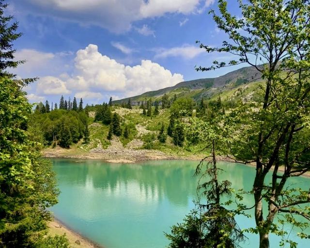 The turquoise Green Lake among mountains and fir trees