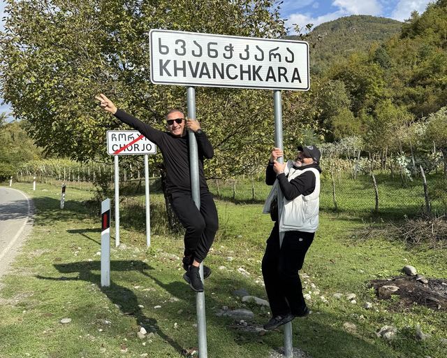 Guests by the Khvanchkara road sign