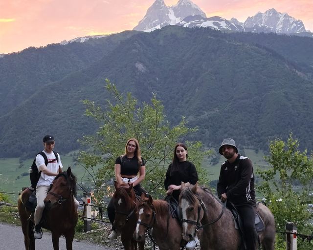 Four riders against a snow-capped peak in Svaneti