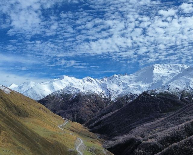 Snow-capped Caucasus peaks beneath the clouds